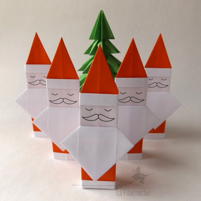 Pères Noël devant un sapin en origami